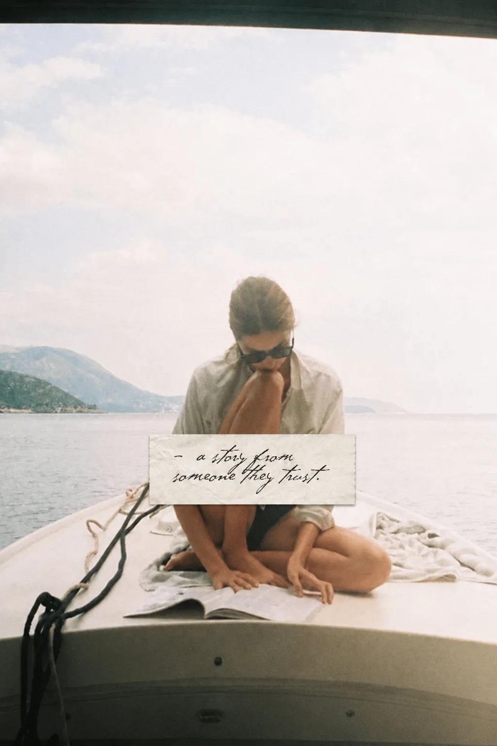 Woman reading on a boat beneath a handwritten note