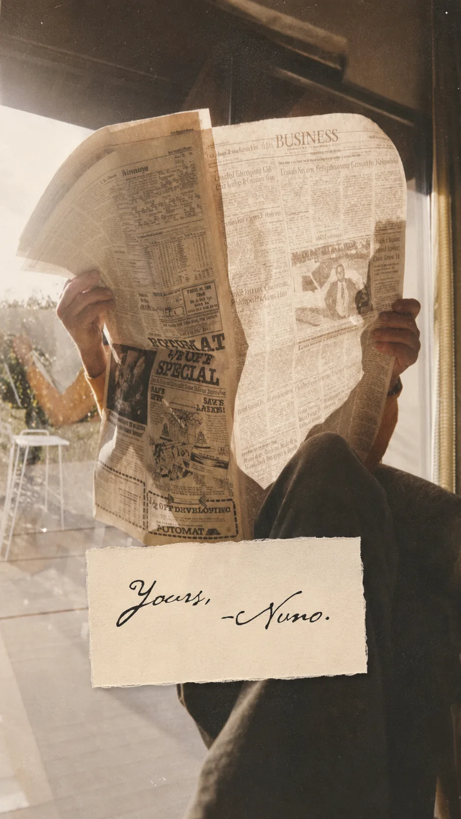 Reader holds a newspaper in morning light